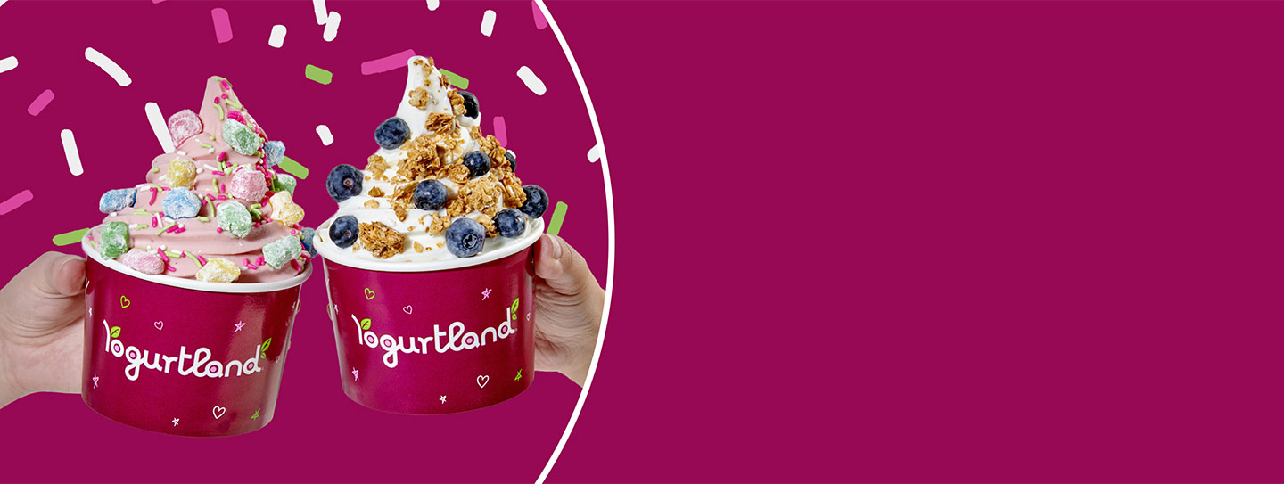 Two Yogurtland frozen yogurt cups with a variety of toppings